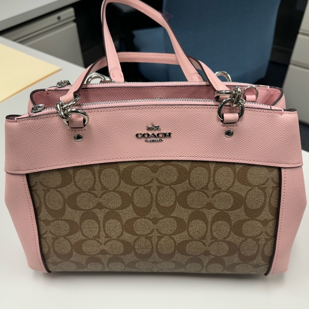Pink and tan coach bag. Slight damage to the handle (pictured)